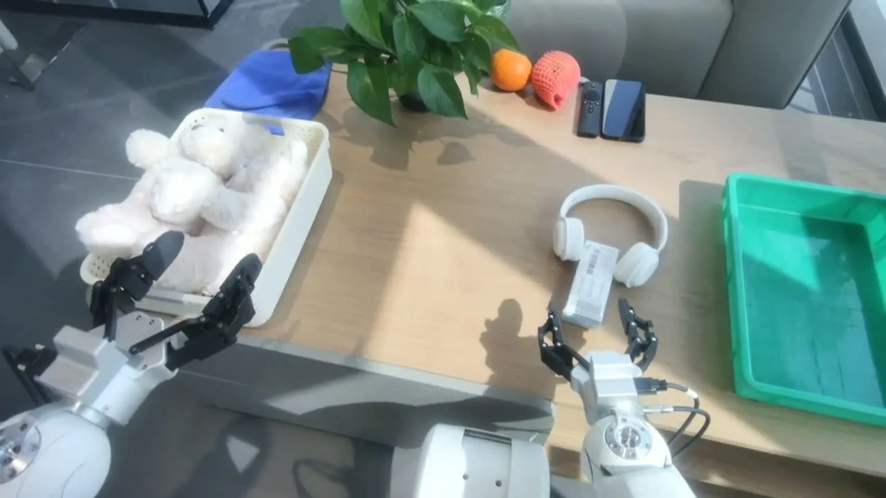 Two robot arms working together on a tabletop task